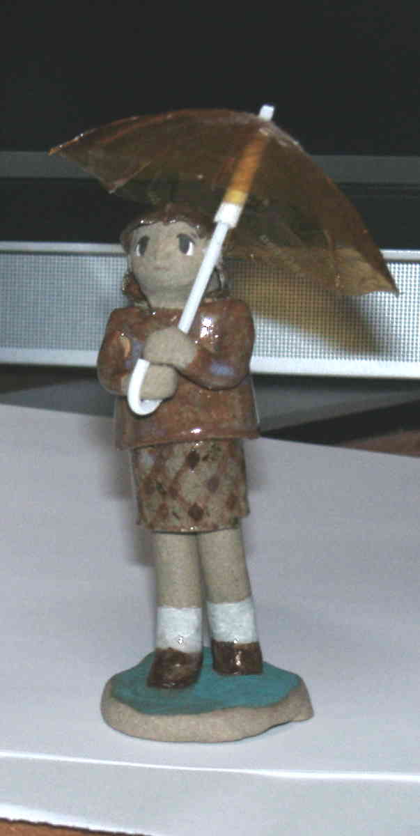 a figure of girl with umbrella